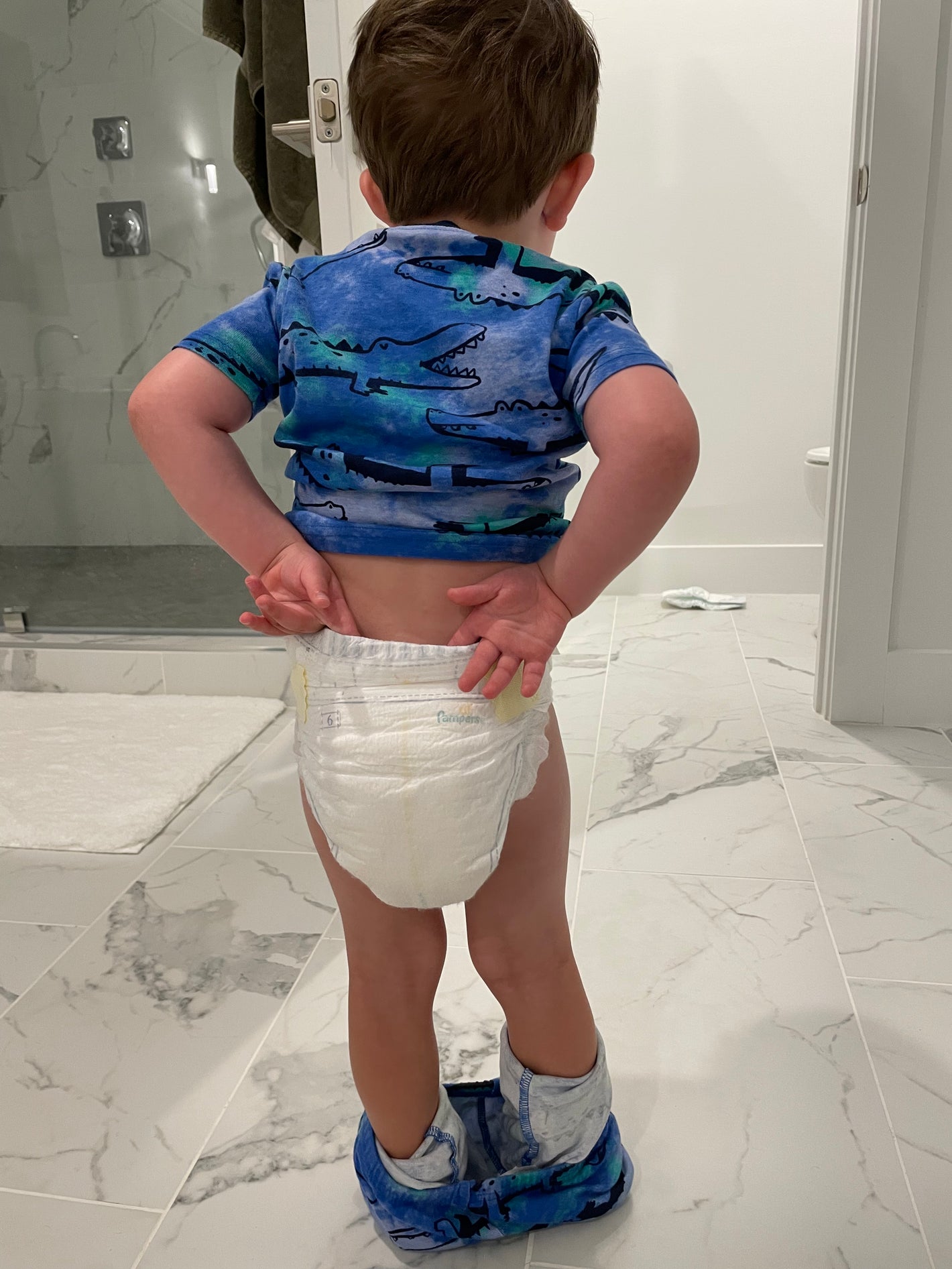 A child in a stroller, eating ice cream 