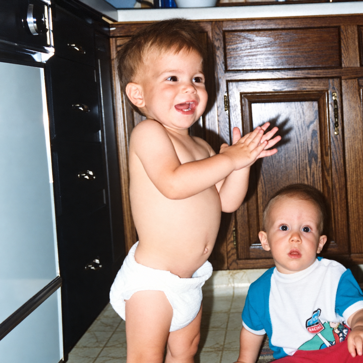 Baby Michael standing in his diaper beside his childhood friend Rob